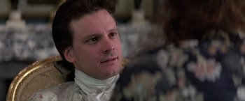 Movie still from “Valmont” (1989), directed by Milos Forman – A person wearing a suit and tie; Close Up shot, Over the shoulder angle