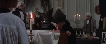 Movie still from “Valmont” (1989), directed by Milos Forman – An old woman kissing a young woman in a room; Medium shot, High angle
