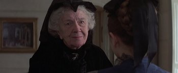 Movie still from “Valmont” (1989), directed by Milos Forman – An older woman wearing a black hat looking in the mirror; Close Up shot, Over the shoulder angle