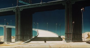 Movie still from “Vampire Hunter D: Bloodlust” (2000), directed by Yoshiaki Kawajiri – A person standing on a beach under an overpass; Extreme Wide shot, High angle