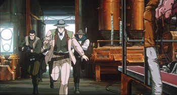 Movie still from “Vampire Hunter D: Bloodlust” (2000), directed by Yoshiaki Kawajiri – A man walking down a street while holding a cell phone to his ear; Wide shot, Low angle