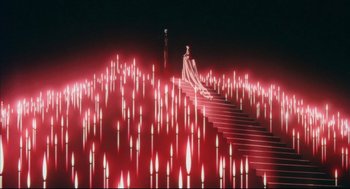 Movie still from “Vampire Hunter D: Bloodlust” (2000), directed by Yoshiaki Kawajiri – A woman standing on top of a set of stairs; Extreme Wide shot, High angle
