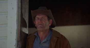 Movie still from “Vanishing Point” (1971), directed by Richard C. Sarafian – An older man wearing a cowboy hat and a brown jacket; Close Up shot, Low angle