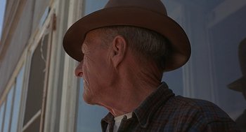 Movie still from “Vanishing Point” (1971), directed by Richard C. Sarafian – An older man wearing a brown hat and a plaid shirt; Close Up shot, Low angle