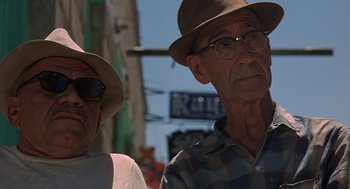 Movie still from “Vanishing Point” (1971), directed by Richard C. Sarafian – Two older men wearing hats and glasses on a city street; Close Up shot, Low angle