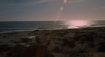 Movie still from “Vanishing Point” (1971), directed by Richard C. Sarafian – A truck parked on a beach near the ocean; Extreme Wide shot, High angle