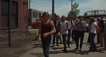 Movie still from “Vanishing Point” (1971), directed by Richard C. Sarafian – A group of people walking down a street; Wide shot, High angle
