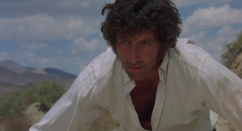 Movie still from “Vanishing Point” (1971), directed by Richard C. Sarafian – A person wearing a white shirt; Close Up shot, Low angle