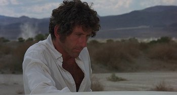 Movie still from “Vanishing Point” (1971), directed by Richard C. Sarafian – A person wearing a white shirt; Close Up shot, Low angle