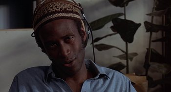 Movie still from “Vanishing Point” (1971), directed by Richard C. Sarafian – A person wearing headphones; Close Up shot, Low angle