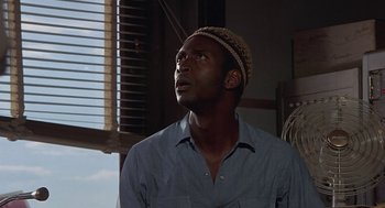 Movie still from “Vanishing Point” (1971), directed by Richard C. Sarafian – A man wearing a hat looking up into the sky; Close Up shot, Low angle