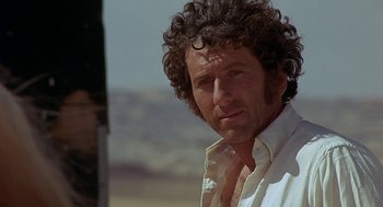 Movie still from “Vanishing Point” (1971), directed by Richard C. Sarafian – A person wearing a shirt; Close Up shot, Low angle
