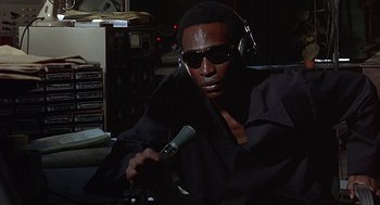Movie still from “Vanishing Point” (1971), directed by Richard C. Sarafian – A man with headphones and a microphone in a room; Close Up shot, High angle