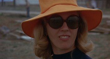 A person wearing sunglasses and a hat