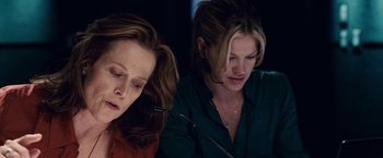 Movie still from “Vantage Point” (2008), directed by Pete Travis – Two women sitting in front of each other; Close Up shot, Low angle