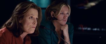 Movie still from “Vantage Point” (2008), directed by Pete Travis – Two women sitting next to each other in front of a microphone; Close Up shot, Low angle