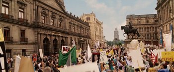 Movie still from “Vantage Point” (2008), directed by Pete Travis – A large crowd of people are gathered on the street; Extreme Wide shot, High angle