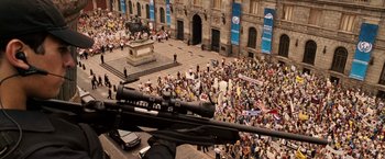 Movie still from “Vantage Point” (2008), directed by Pete Travis – A large crowd of people gathered in the street; Extreme Wide shot, High angle