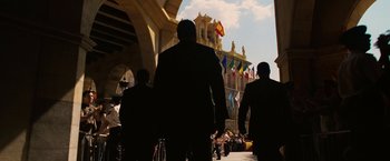 Movie still from “Vantage Point” (2008), directed by Pete Travis – A group of people walking down a street; Wide shot, Low angle