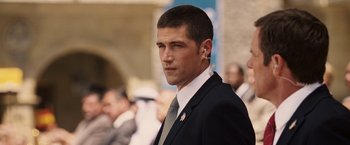 Movie still from “Vantage Point” (2008), directed by Pete Travis – A person wearing a suit and tie; Close Up shot, Over the shoulder angle