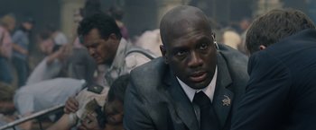 Movie still from “Vantage Point” (2008), directed by Pete Travis – A man in a suit and tie sitting next to another man in a suit and tie; Close Up shot, Over the shoulder angle