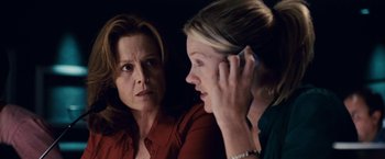 Movie still from “Vantage Point” (2008), directed by Pete Travis – A woman talking to another woman on a cell phone; Close Up shot, Over the shoulder angle