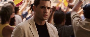 Movie still from “Vantage Point” (2008), directed by Pete Travis – A person wearing a jacket; Close Up shot, Over the shoulder angle