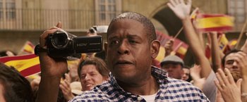 Movie still from “Vantage Point” (2008), directed by Pete Travis – A person holding a video camera; Close Up shot, Low angle