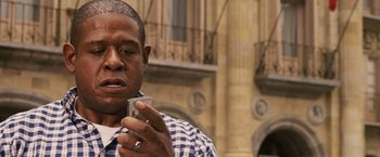 Movie still from “Vantage Point” (2008), directed by Pete Travis – A person using a cell phone; Close Up shot, Low angle