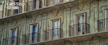 Movie still from “Vantage Point” (2008), directed by Pete Travis – A building with balconies on the side of the building; Extreme Close Up shot, Low angle