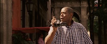 Movie still from “Vantage Point” (2008), directed by Pete Travis – A man is holding a video camera up to his face; Close Up shot, Low angle