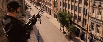 Movie still from “Vantage Point” (2008), directed by Pete Travis – A street view of a street with a large gun on it's side; Wide shot, High angle