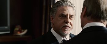 Movie still from “Vantage Point” (2008), directed by Pete Travis – An older man wearing a suit and tie; Close Up shot, Low angle