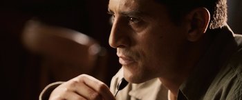 Movie still from “Vantage Point” (2008), directed by Pete Travis – A person with a microphone; Close Up shot, Over the shoulder angle