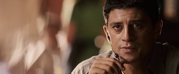 Movie still from “Vantage Point” (2008), directed by Pete Travis – A person wearing a pair of ear buds; Close Up shot, Over the shoulder angle