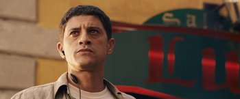 Movie still from “Vantage Point” (2008), directed by Pete Travis – A person wearing headphones; Close Up shot, Low angle