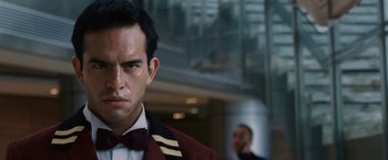 Movie still from “Vantage Point” (2008), directed by Pete Travis – A person wearing a suit and bow tie; Close Up shot, Low angle