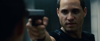 Movie still from “Vantage Point” (2008), directed by Pete Travis – A person holding a gun in his hand; Close Up shot, Low angle