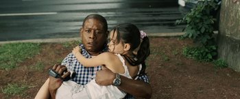 Movie still from “Vantage Point” (2008), directed by Pete Travis – A man and a little girl hugging each other; Medium shot, High angle