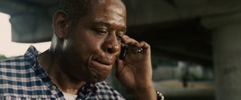 Movie still from “Vantage Point” (2008), directed by Pete Travis – A person talking on a cell phone; Close Up shot, Low angle