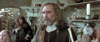 Movie still from “Vatel” (2000), directed by Roland Joffé – An older man with long hair and a beard; Close Up shot, Over the shoulder angle