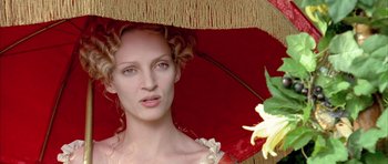 Movie still from “Vatel” (2000), directed by Roland Joffé – A beautiful woman with a red umbrella and a flower; Close Up shot, Low angle