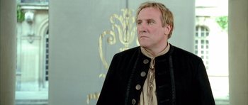 Movie still from “Vatel” (2000), directed by Roland Joffé – A man wearing a black jacket and a black shirt; Close Up shot, Low angle