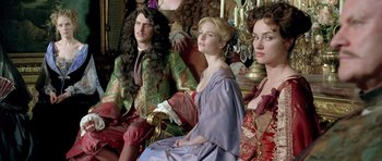 Movie still from “Vatel” (2000), directed by Roland Joffé – A group of people sitting in a room; Medium shot, Low angle