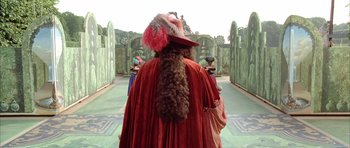Movie still from “Vatel” (2000), directed by Roland Joffé – A man in a red robe and a red hat; Medium shot, Over the shoulder angle