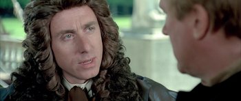 Movie still from “Vatel” (2000), directed by Roland Joffé – A man with long curly hair talking to another man; Close Up shot, Over the shoulder angle