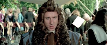 Movie still from “Vatel” (2000), directed by Roland Joffé – A man in a wig and long hair; Close Up shot, Over the shoulder angle