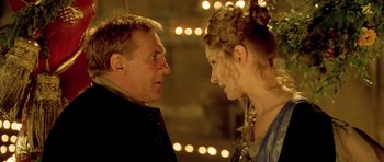 Movie still from “Vatel” (2000), directed by Roland Joffé – A man and a woman face to face in front of lights; Close Up shot, Low angle