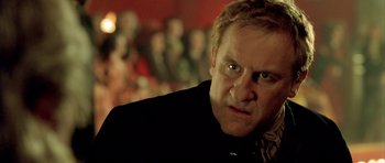 Movie still from “Vatel” (2000), directed by Roland Joffé – A person wearing a black jacket; Close Up shot, Low angle