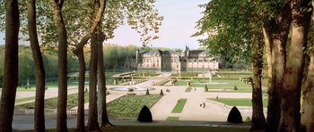 A large garden with a castle in the background